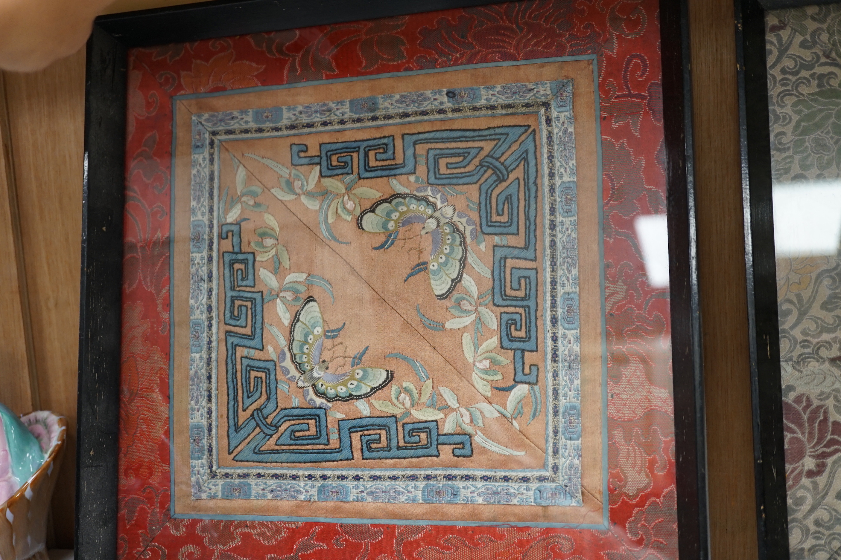 Three framed Chinese silk embroidered panels including a Beijing knot embroidered panel, two with applied butterflies, largest frame 31cm x 31cm